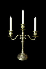 Obraz na płótnie Canvas Triple bronze figurate candelabrum with three unlighted candles, isolated on black background