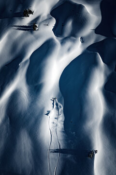 A mand and woman are powder skiing in British Columbia, Canada.