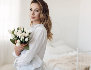 Young pretty woman with tulips flowers bouquet, Spring calm and happy portrait