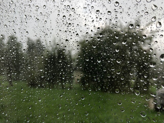rainy drops on the window in summer time 