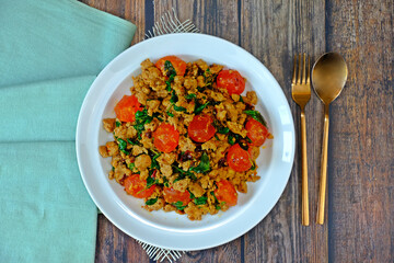 Stir fried spicy minced pork and preserved egg yolk with Thai basil. Authentic Thai food.