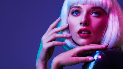 Glamour fashion girl. Beauty face with bright makeup. Young beautiful woman in a white wig, bob hairstyle. Close up art portrait  of  an young attractive woman with vivid colors. Stylish blonde.