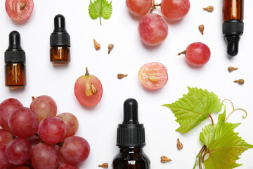 Composition with bottles of natural grape seed oil on white background, top view. Organic cosmetic