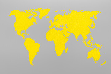World map drawn paint yellow color on a gray background. Minimalistic Creative wallpaper with colors of the year 2021 - Illuminating Yellow and Ultimate Gray