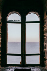 Old castle window overlooking the sea, middle ages