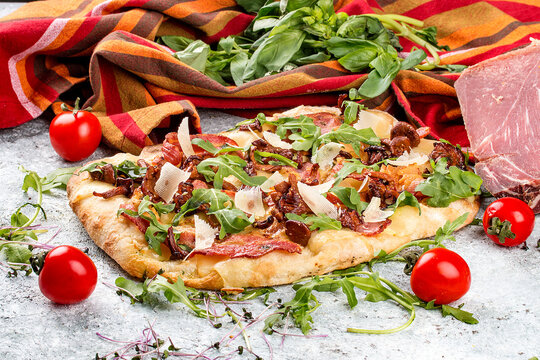 Roman pizza.  Carbonara pinza with bacon, arugula and chanterelles