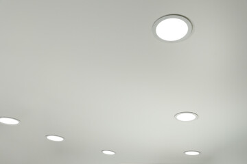 White ceiling with lamps indoors, below view