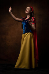A girl in a princess costume. Fairy tale. A brunette. Red lips. 