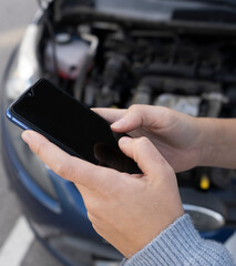 Closeup view of woman hands using phone calling , texting or use car app insurance after vehicle...