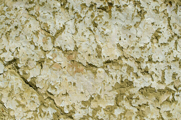 Grunge cracked clay wall. Old clay wall peeling texture background. Old house wall