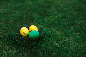 Easter, holidays and tradition concept. Colorful Easter eggs painted in pastel colors on grass background.
