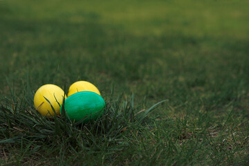 Easter, holidays and tradition concept. Colorful Easter eggs painted in pastel colors on grass background.