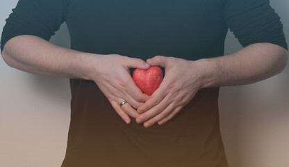 Man holding red heart, health insurance, donation charity concept, heart care.