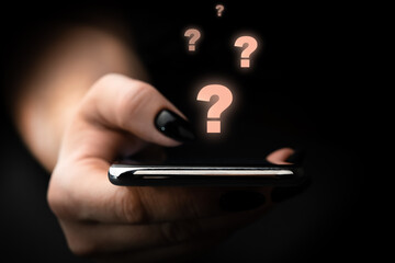 Question marks with person holding smartphone. Find answer online, FAQ concept, what where when how and why, search information on internet