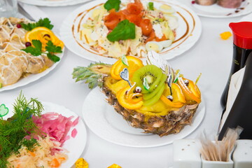 serving salad. salad in a restaurant on a table with a white tablecloth. Table served with dishes for the holiday 