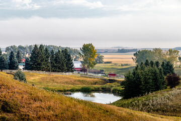 Fototapeta na wymiar Ponds in farmers filedsin fall. Rockyview County, Alberta, Canada