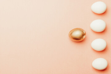 Easter set. Golden, white colour egg on pastel pink background in Happy Easter decoration. Traditional design with copy space.