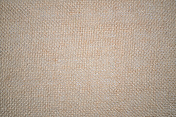 Rough jute texture burlap background in beige colors, natural textile pattern. Sackcloth or bagging packaging textile. Vintage grungy backdrop