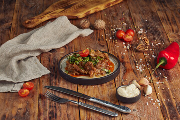 Beef stew with vegetables, georgian cuisine, wooden background