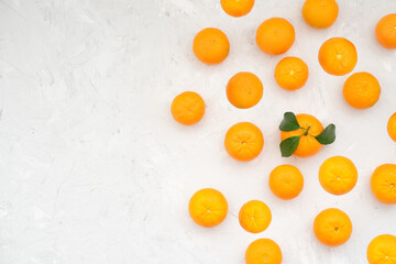 Tangerines on white background. Good harvest of ripe and large tangerines has been harvested. To improve health and replenish the body with vitamins, you can prepare wonderful fresh juice. Close-up