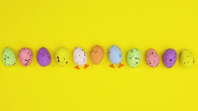 Easter eggs move and two with legs step out on yellow theme  Stop motion 
