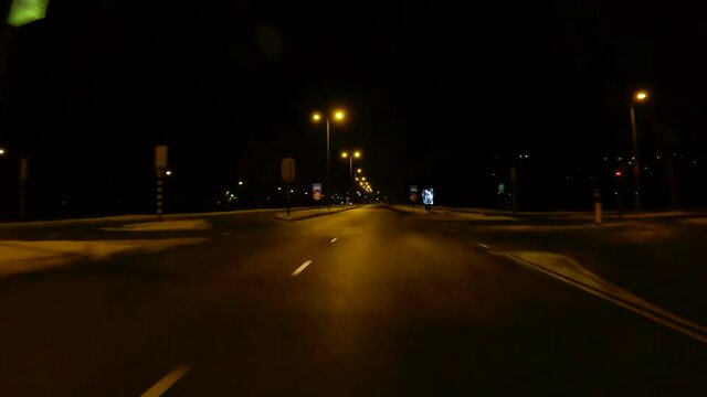 Netherlands - 10 februari 2021, Utrecht: Night-time curfew during corona time POV driving through empty streets timelapse