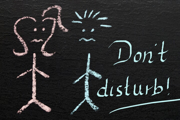 chalkboard with two drawn sad children and the words "Don't disturb"