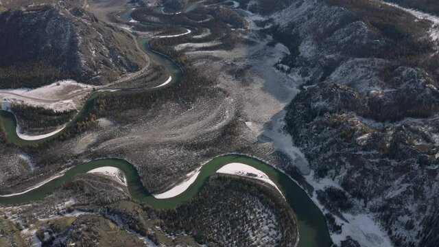 Aerial shot of snake river among snow mountains