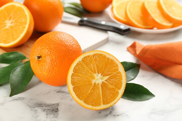 Delicious ripe oranges on white marble table