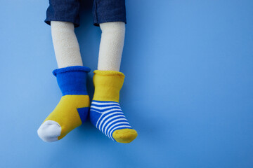 World Down syndrome day background. Down syndrome awareness concept. Toy legs with different socks...