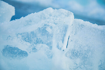 Fototapeta na wymiar Textured frozen ice. Figured blocks of natural ice. 