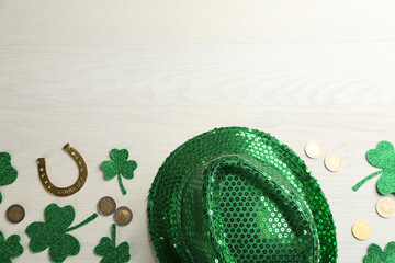 Flat lay composition with leprechaun hat on white wooden table, space for text. St Patrick's Day...