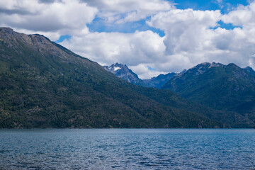 Obraz premium Hermosos paisaje de montañas y río con vegetación y nubes vistosas