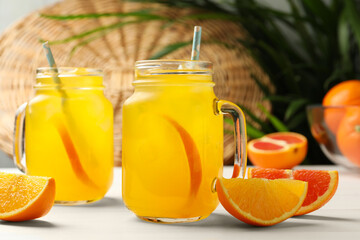 Delicious orange soda water on white wooden table