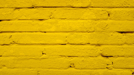 Old brick wall texture of stone blocks closeup for yellow background.