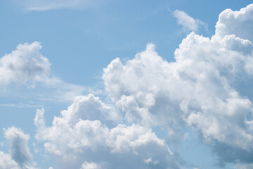 White clouds in the blue sky on a sunny day. Background with large clouds close-up.