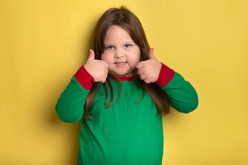 Funny little girl giving thumbs up