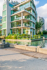 Modern Apartment Buildings with flowers and water landscape in Vancouver, British Columbia, Canada.