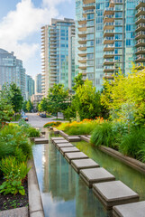 Modern Apartment Buildings with flowers and water landscape in Vancouver, British Columbia, Canada.