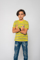 Studio shot of attractive teenager boy against grey background