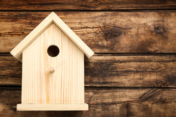 Obraz na płótnie Canvas Beautiful bird house on wooden background, space for text