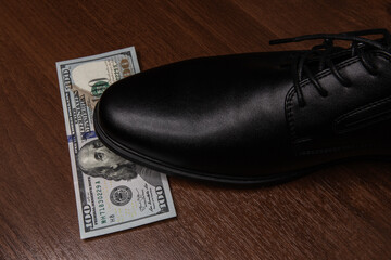 leather shoe steps on the dollar