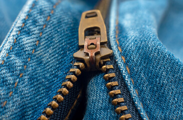 Closeup of zipper in blue jeans. Zipper with lock. A piece of denim