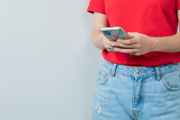 Young girl in red shirt holding a smartphone