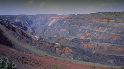 open pit, iron ore quarry, panoramic industrial landscape.