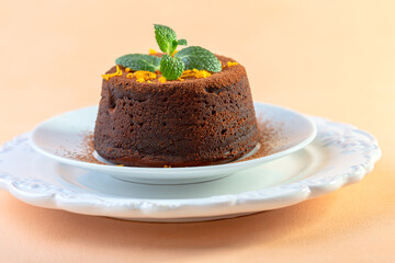 Warm chocolate dessert with orange peel and mint.