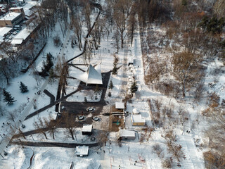 Aerial view Kharkiv city center popular recreation park Sarzhyn Yar covered in snow. Botanical garden water spring winter cityscape