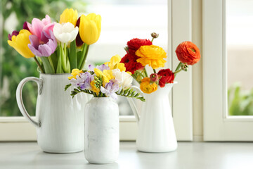 Different beautiful spring flowers on window sill