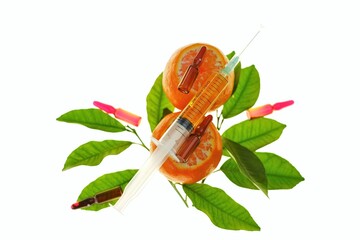 Vitamin C. Serum with Vitamin C. Glass ampoules close-up on tangerines fruits with bright green...