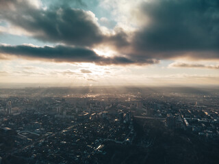 Aerial panorama view of Kharkiv city center with Park, Botanical garden, stadium and residential multistorey buildings with scenic dark moody sky in winter